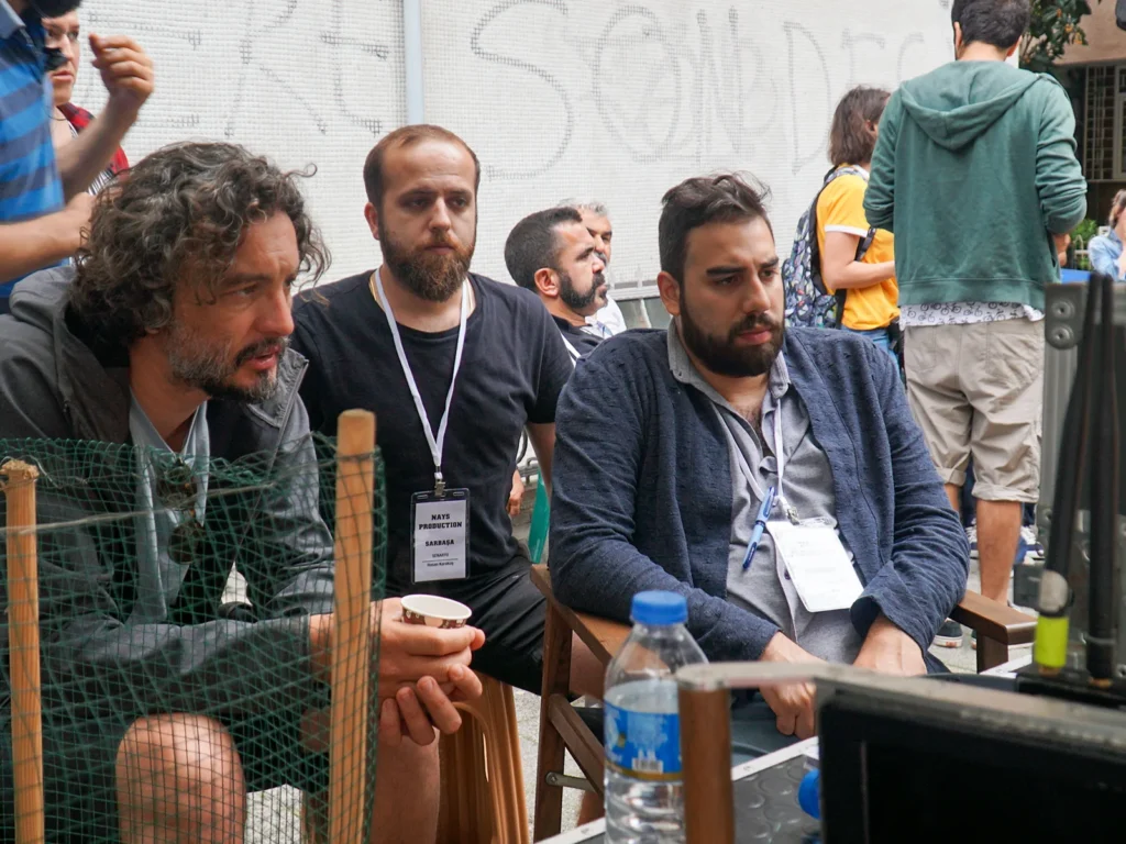 Director and crew reviewing the shoot on the set of Sar Başa