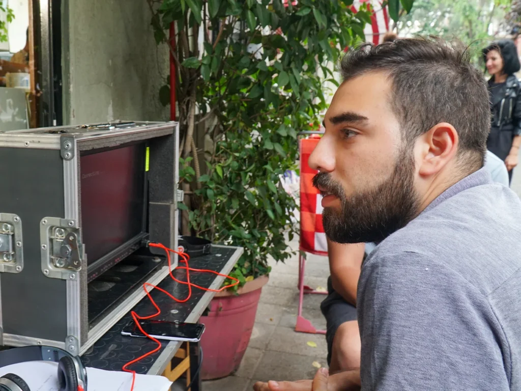 Director monitoring a shot during the production of Sar Başa